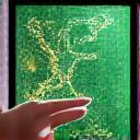 Image of a hand holding a stylus interacting with a tablet displaying garden design software